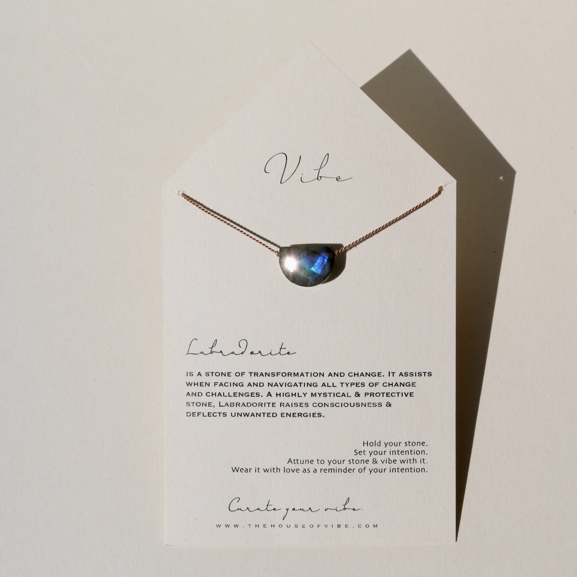 labradorite necklace on display card with stone meaning text